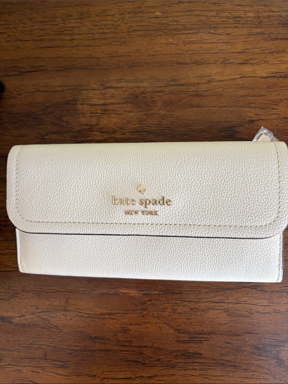 kate spade cream pebbled leather flap continental wallet with gold logo